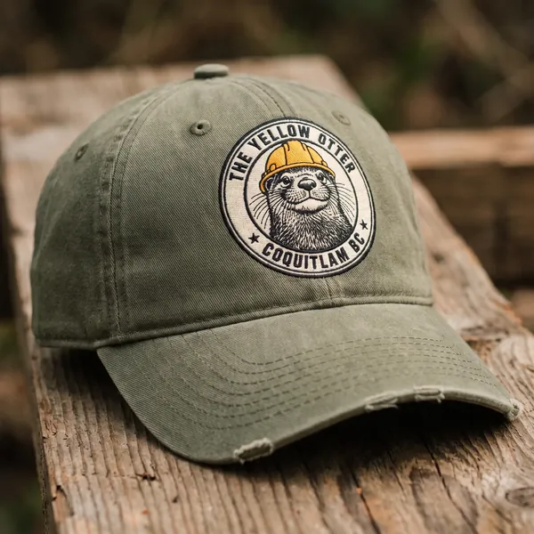 An olive cap embroidered with the Yellow Otter badge